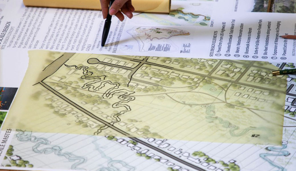 Engineering team overlays design ideas with maps of Tybee Island.