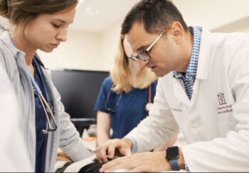 Two UGA veterinarians working on a dog