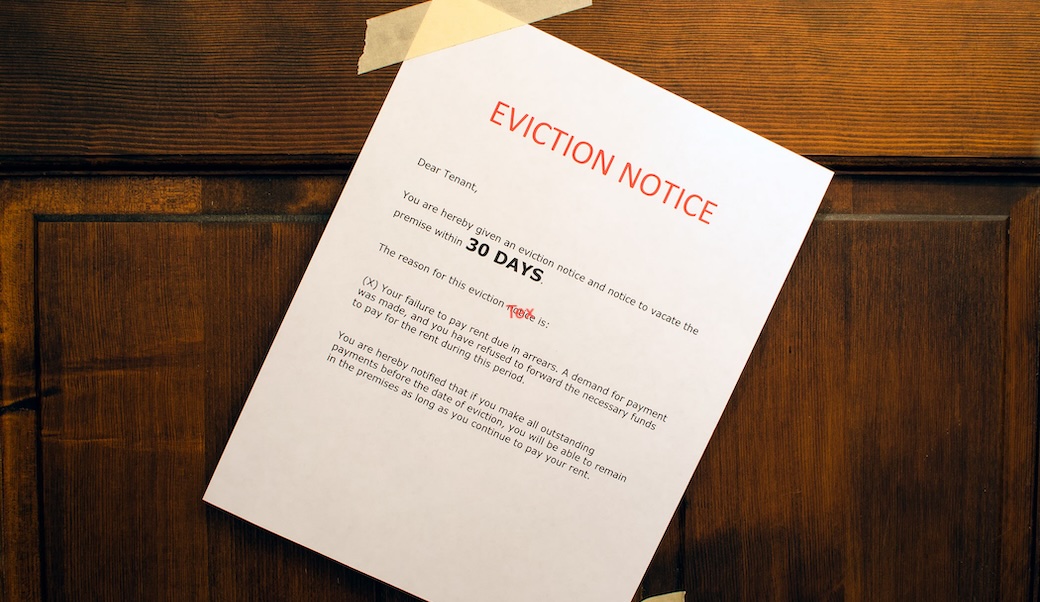 Image of an eviction notice pasted to a front door.