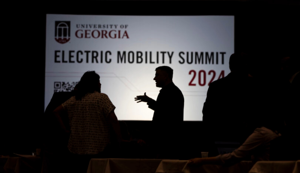 Attendees socialize with each other before the start of the 2024 Electric Mobility Summit at the Classic Center.