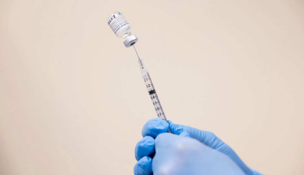 Close-up photo of the COVID-19 vaccine being drawn into a needle.