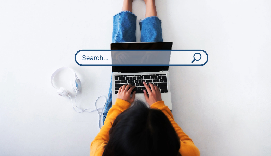 Bird's eye view of a woman on a laptop. Caption: The study found participants who used positive emotion search terms — such as joyful, or cheerful — to describe a water bottle were more than twice as likely to click on ads at the top of their search results than people who used non-emotion descriptors. (Getty Images)