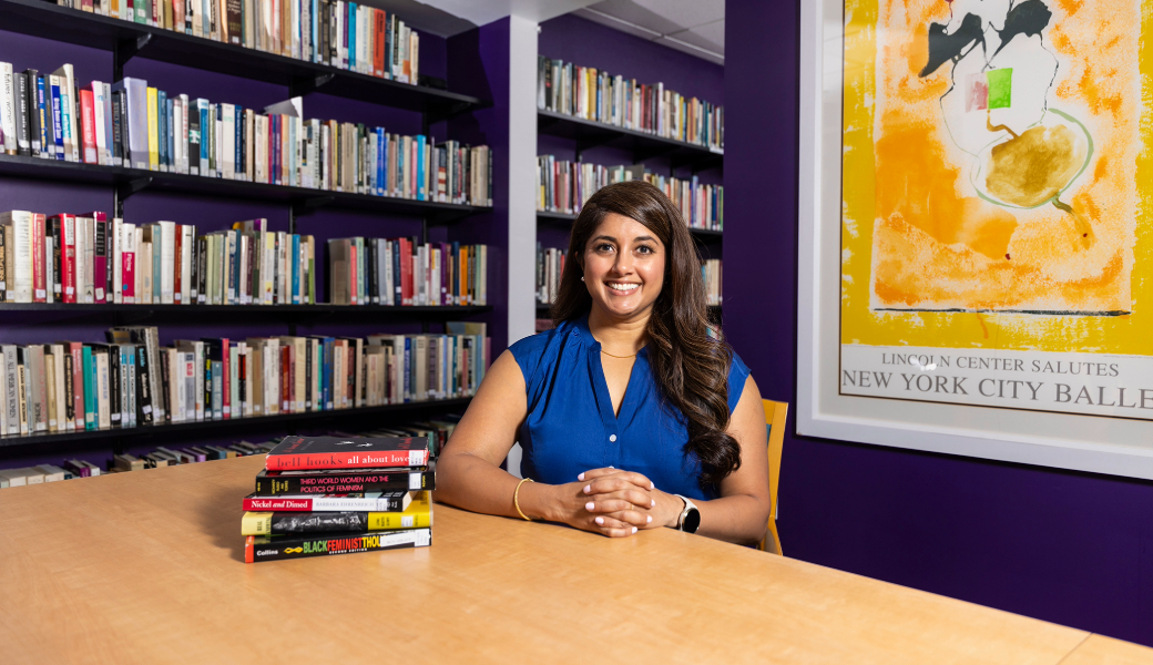 An image of Rumya Putcha sitting at a table in a library. Rumya Putcha is an associate professor of music and women’s studies in the Franklin College of Arts and Sciences.