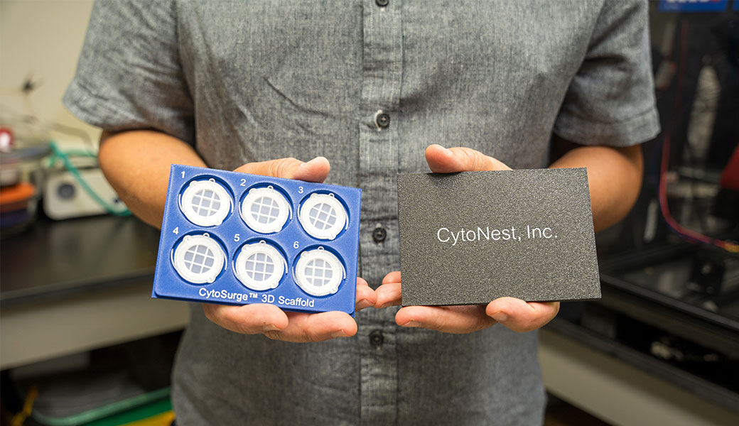 A person holds prototypes for CytoNest Inc. first commercial product, a fiber scaffold to optimize cell manufacturing