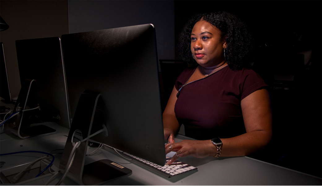 Image of August Jenkins working at a desktop.