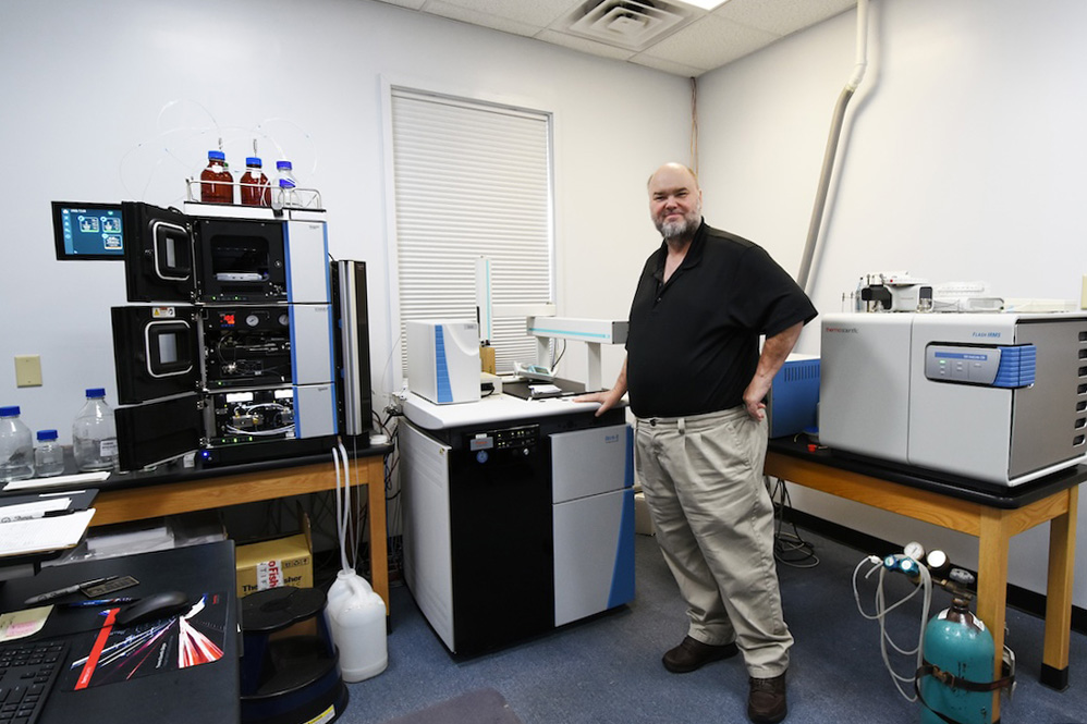 Jay Brandes stands with the new isotope ratio mass spectrometry system in the Skidaway Island Stable Isotope Laboratory.