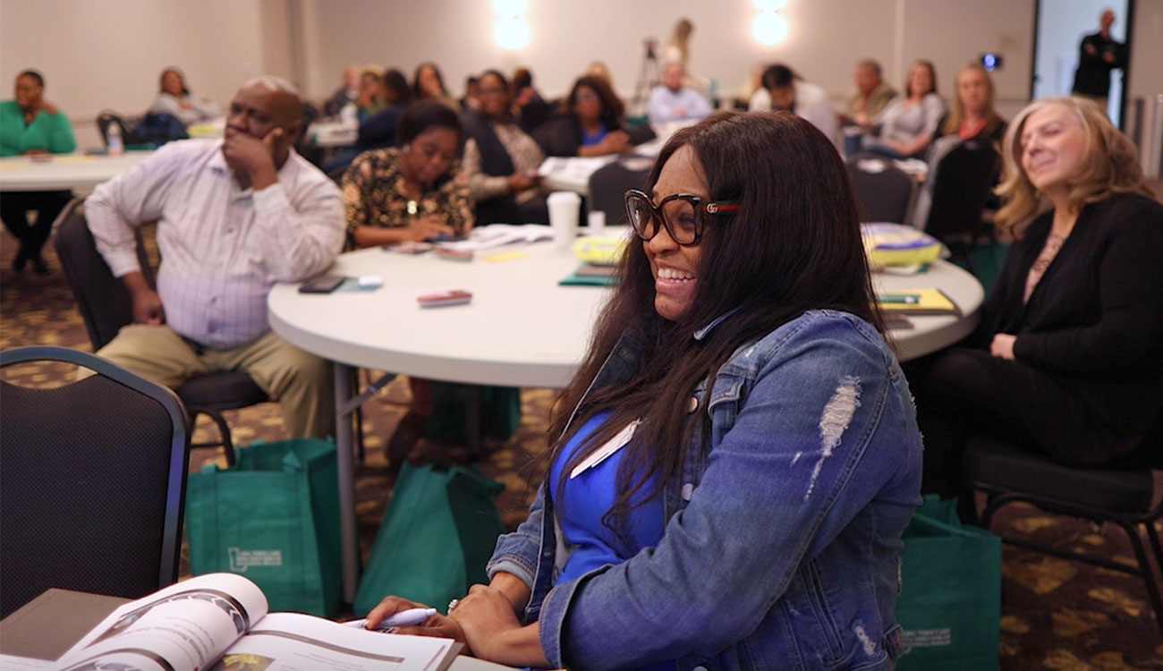 A group of health care workers listen during a presentation on preparedness in long-term care communities.