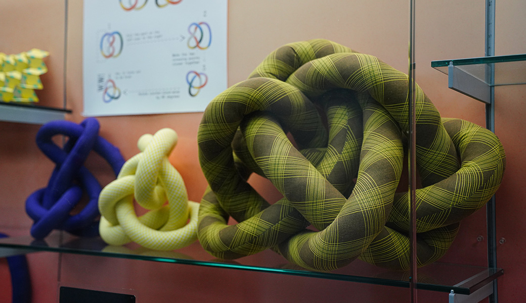 Fabric knots with diagrams about the field of knot theory on view in Spacing Out at the UGA McBay Science Library. Photo courtesy of Sidney Chansamone.