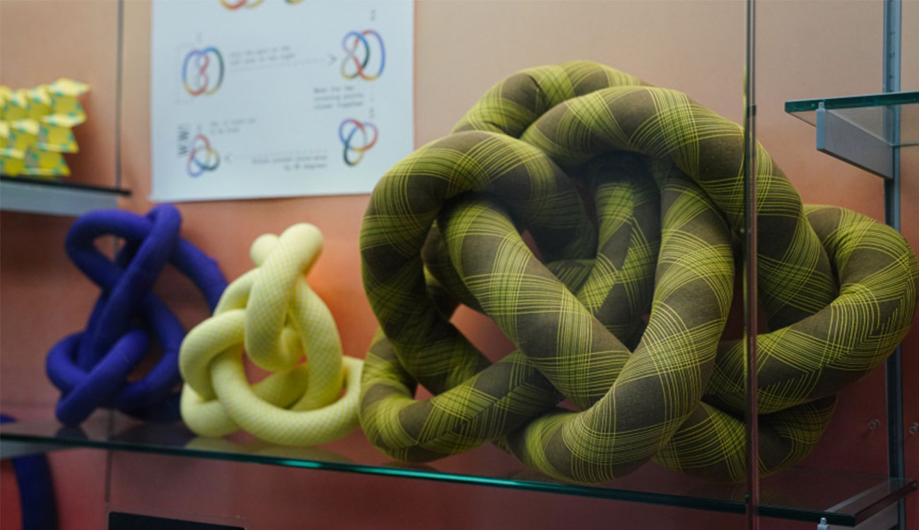 Fabric knots with diagrams about the field of knot theory on view in Spacing Out at the UGA McBay Science Library.