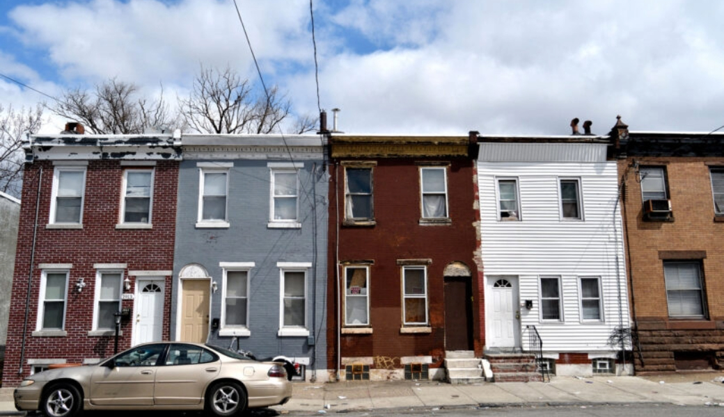 An image of a neighborhood with colorful buildings close together.