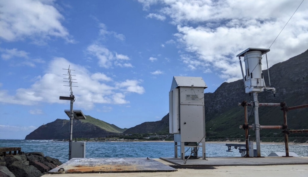 A total suspended particle sampler, which filters the air for aerosol particles, and a rain sampler set up on a monitoring station near Oahu, Hawaii. (Photo courtesy of SkIO faculty member Clifton Buck.)