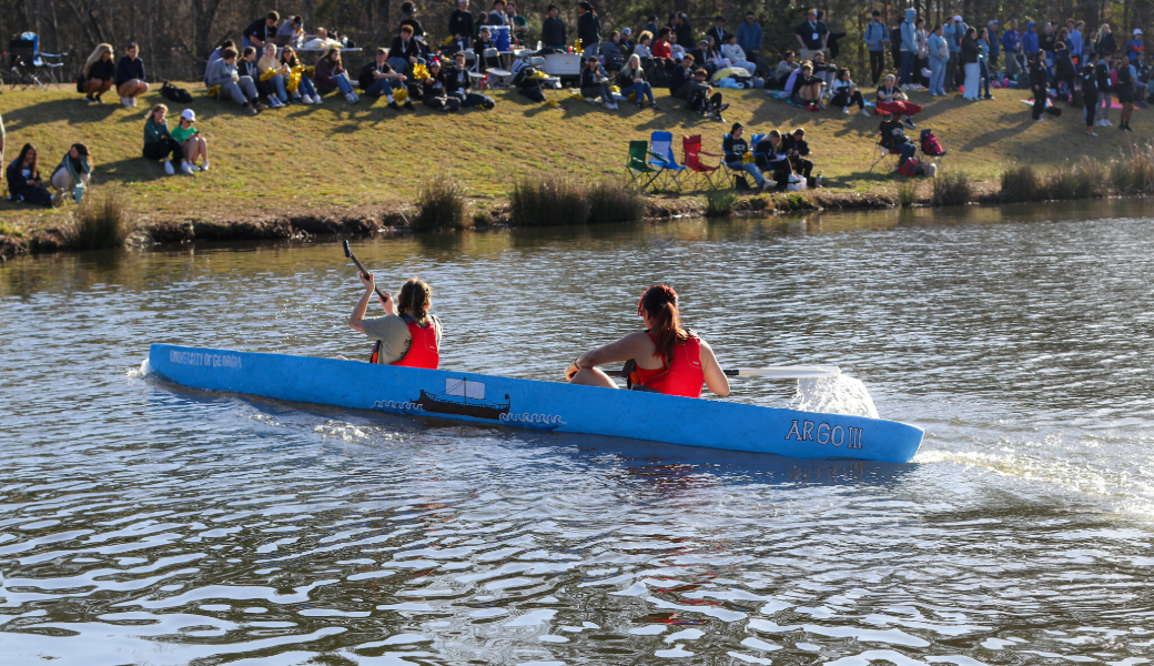 The University of Georgia team paddles in their 2025 concrete canoe, Argo III, on Lake Herrick.