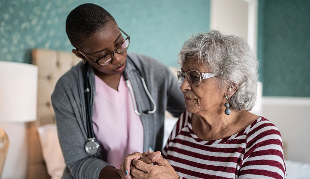 Woman with nurse getting treatment for Alzheimers.