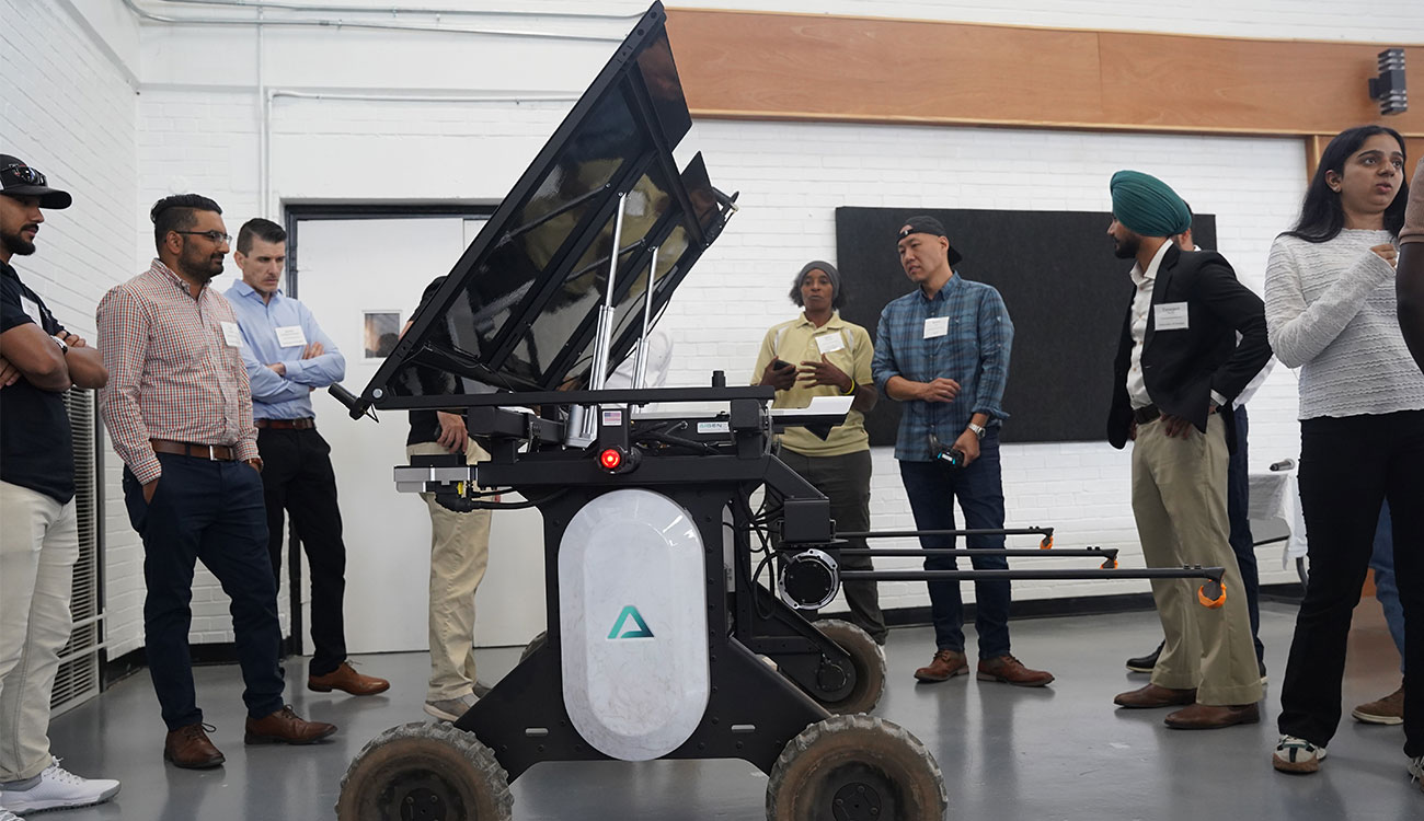 Aigen co-founder Kenny Lee (third from right) demonstrates the Aigen Element, an autonomous weeding system for farms, at last week's Integrative Precision Agriculture Conference. Lee was one of eight UGA Grand Farm partners to present at the conference.