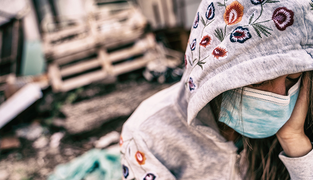 Girl with mask on trying to protect herself from airborne pathogens.
