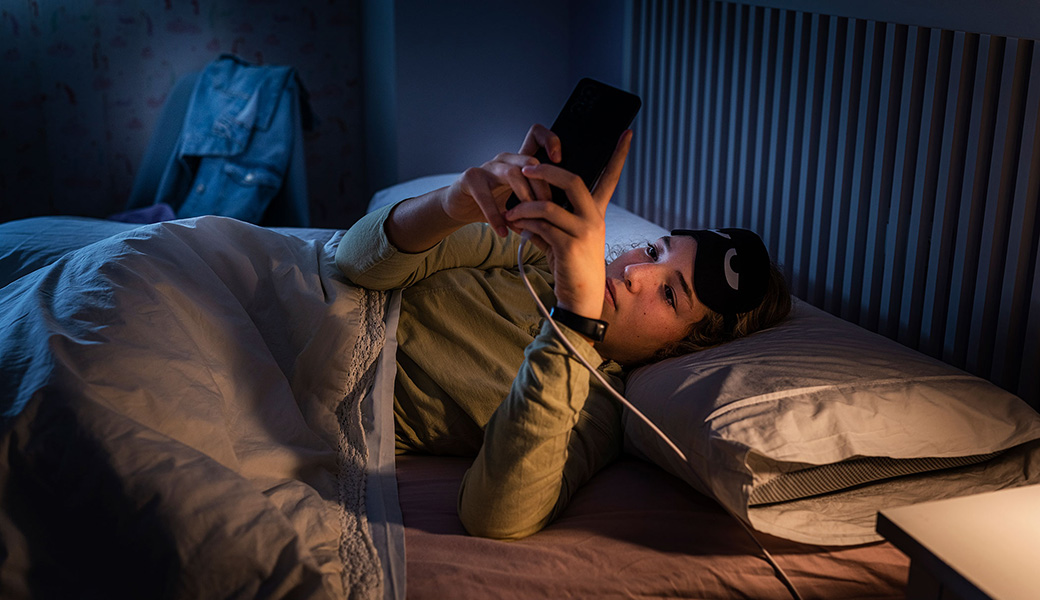 Teen on phone before bedtime.