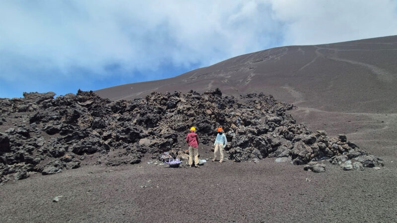 As part of their Mt. Etna research, Tonato (left) and Abigail Verna (right) collected samples in front of a lava deposit generated in February-March 2025 at Mt Etna. The lab’s goal is to investigate the mineral record from magmatic and metamorphic rocks, study volcanic eruption dynamics, and quantify volatile cycles in the Earth’s interior. (Photo provided by Mattia Pistone)