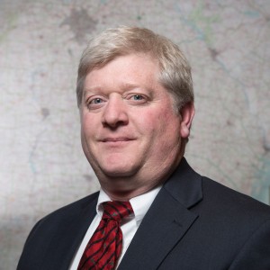 UGA researcher standing in front of map