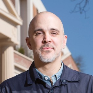 Poet Ed Pavlic standing in front of building