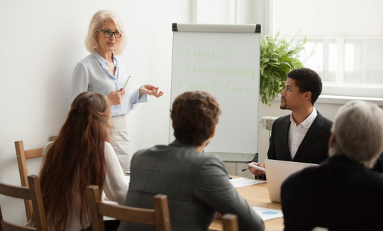 woman leading meeting in conference room
